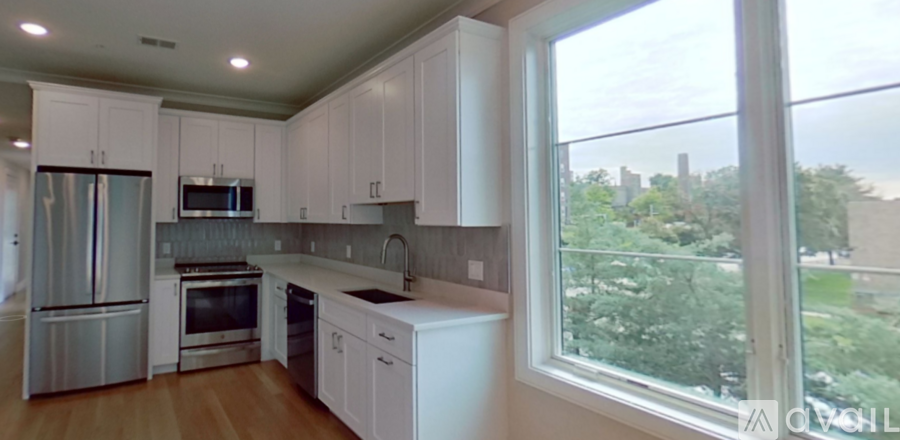 A kitchen with white cabinets and stainless steel appliances.