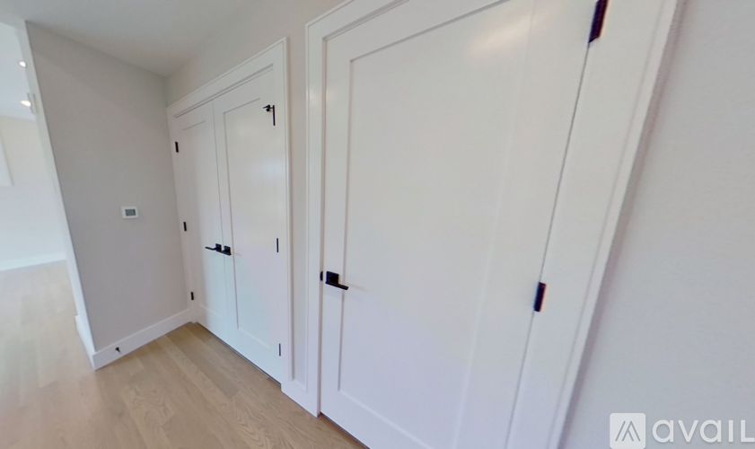 Three white doors in a hallway.