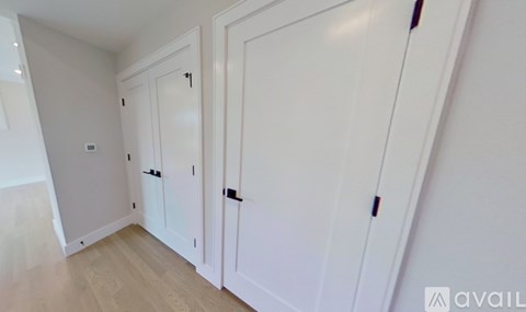 Three white doors in a hallway.