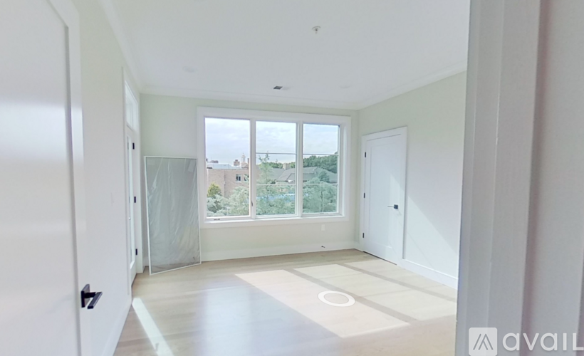 A spacious room with a view of the outdoors through the windows.