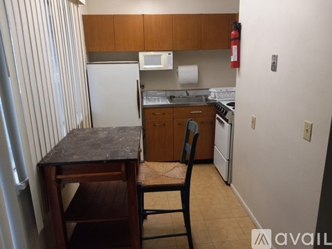 A kitchen with a table and a chair.