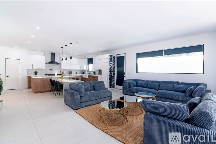 A modern living room with a grey sofa and a wooden coffee table.