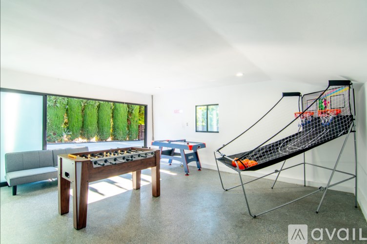 A room with a table, chairs, and a hammock.