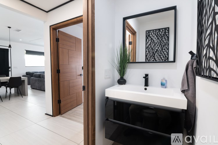 A bathroom with a white sink and a mirror above it.