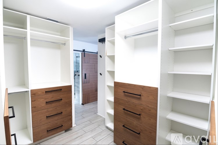 A white and wood storage unit with drawers and shelves.