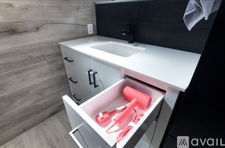 A bathroom sink with a drawer underneath it.