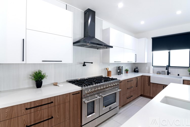 A modern kitchen with wooden cabinets and stainless steel appliances.