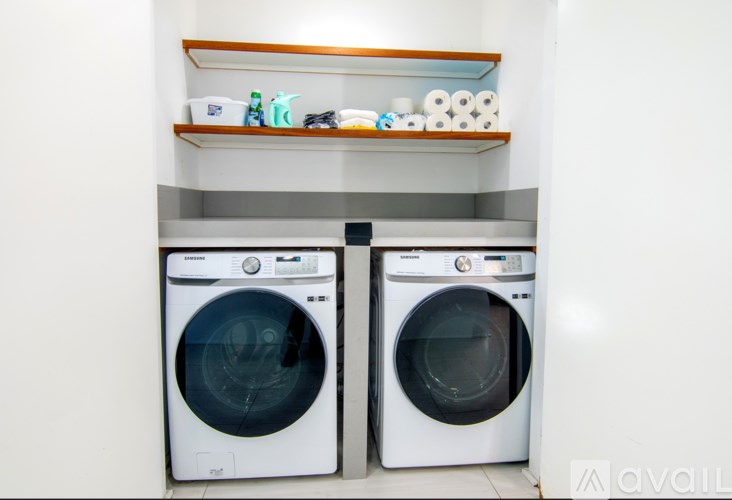 Two front load washing machines in a laundry room.