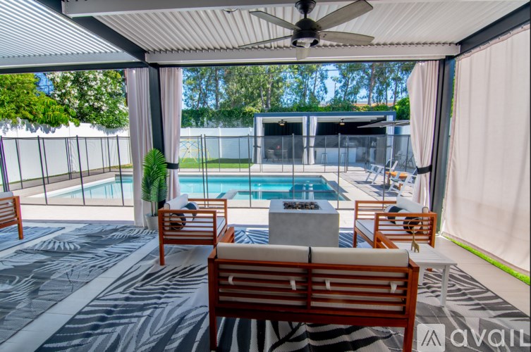 A patio with a pool table and chairs.