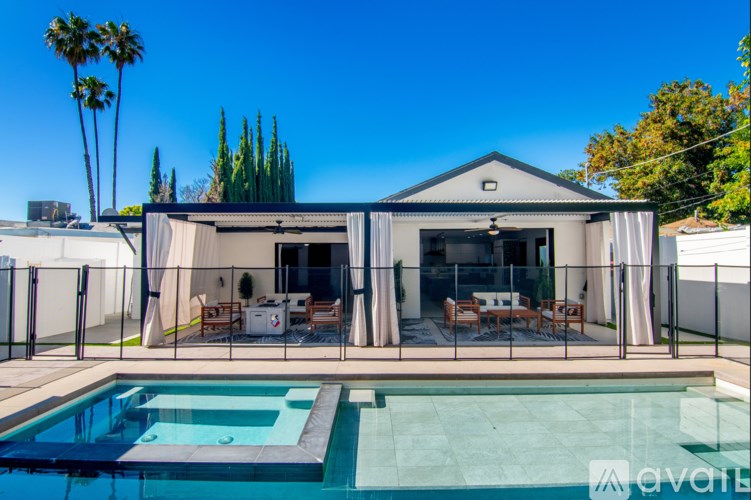 A modern house with a pool in the backyard.