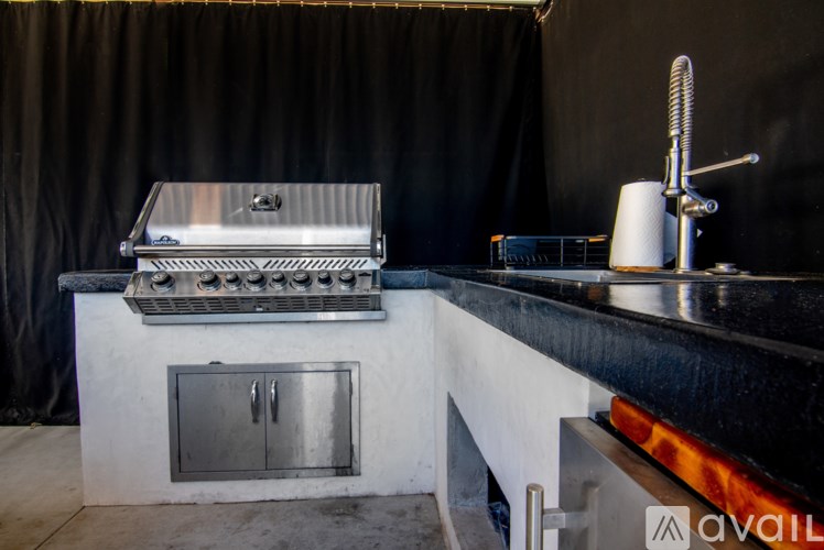A stainless steel grill is on a white countertop.
