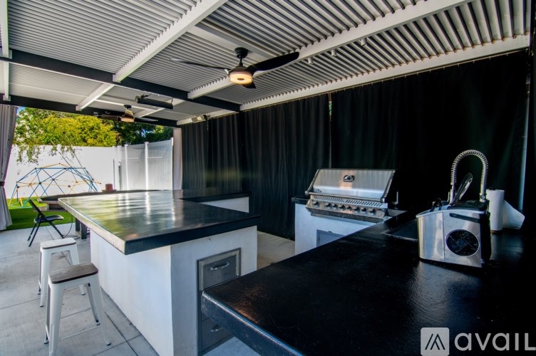 A black countertop with a silver toaster on it.