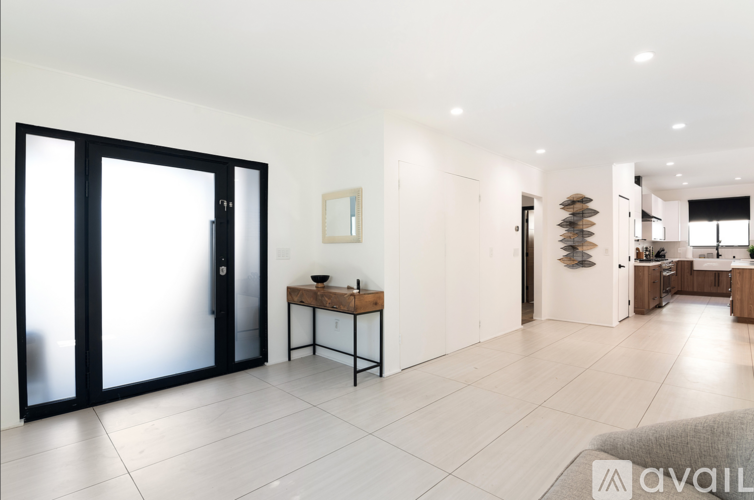 A modern kitchen with a table and chairs in the middle of the room.