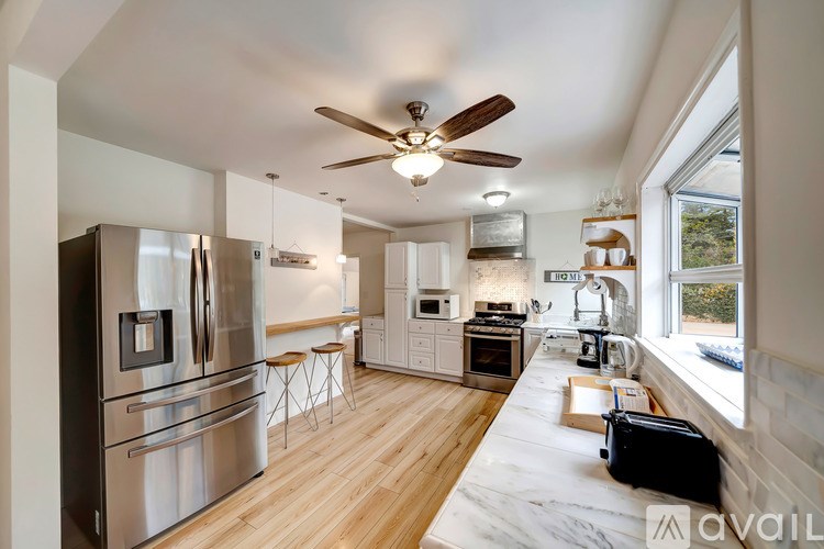 A kitchen with a refrigerator, stove, and oven.
