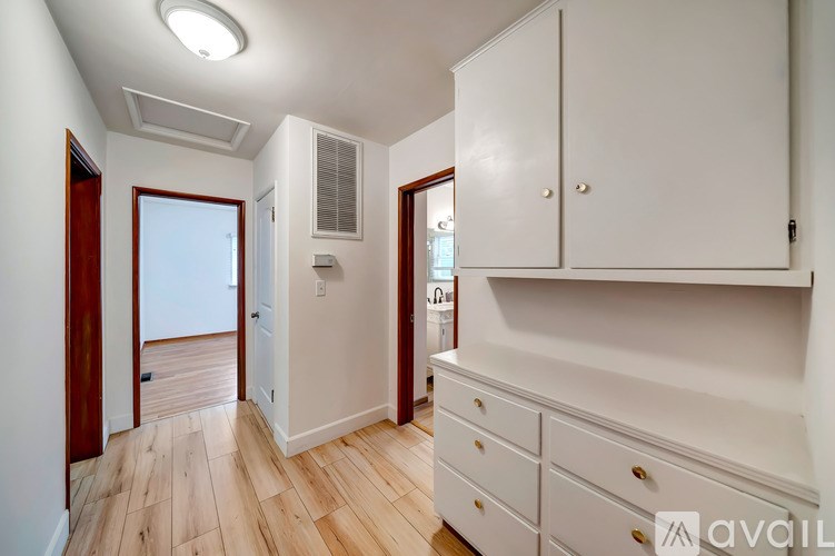 A room with white cabinets and a window.