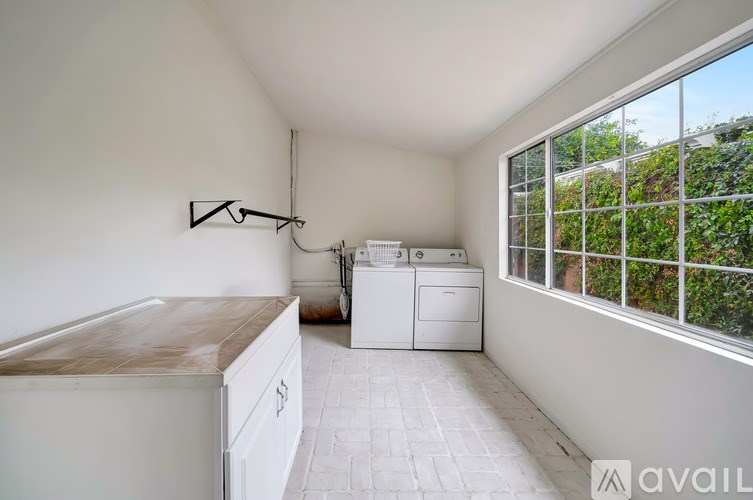 A kitchen with a washing machine and dryer in it.