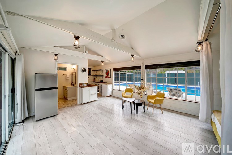 A spacious kitchen and dining area with a view of the pool outside.