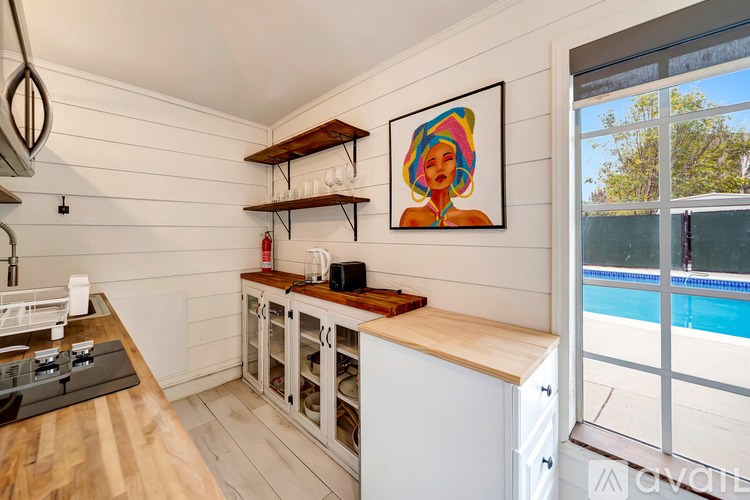 A kitchen with a wooden counter and a fridge.