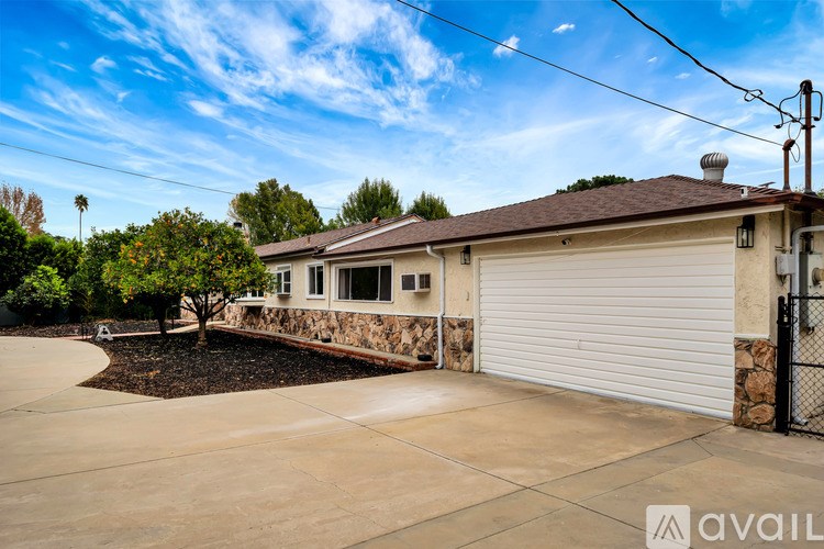 A house with a white garage door and a brown roof.