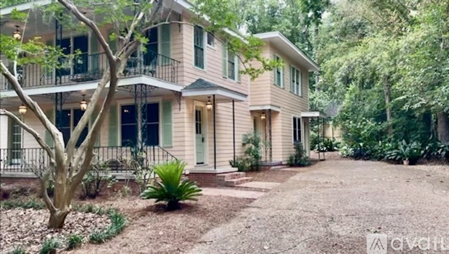 A house with a tree in front of it.