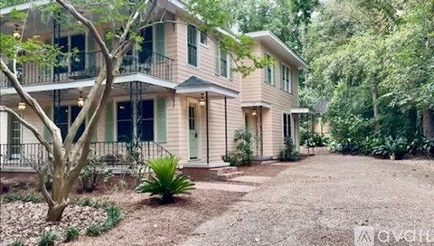 A house with a tree in front of it.