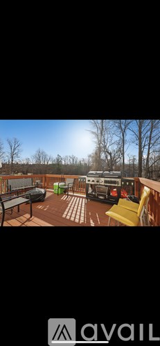 A balcony with a table and chairs overlooking a snowy landscape.