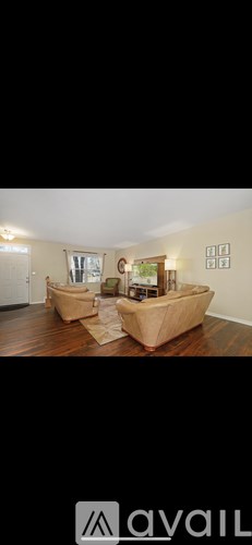 A room with two couches and a table in the middle.