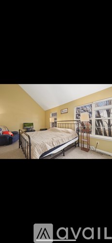 A bedroom with a bed, a dresser, and a window.