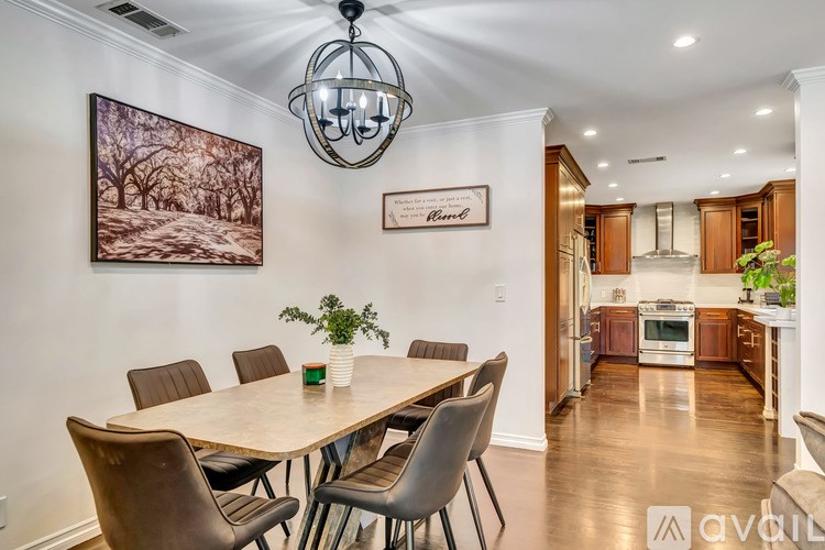 A dining room with a wooden table and chairs.