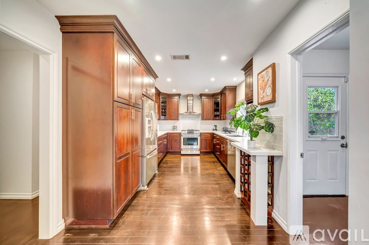 A kitchen with wooden cabinets and a white countertop.