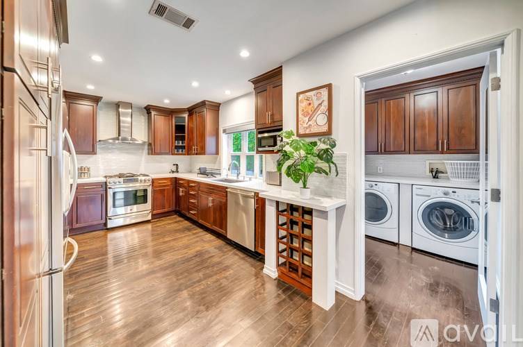 A kitchen with wooden floors and a variety of appliances.
