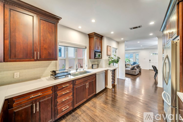 A kitchen with wooden cabinets and a white countertop.