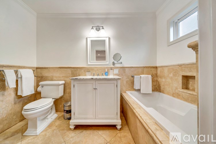 A bathroom with a toilet, sink, and bathtub.