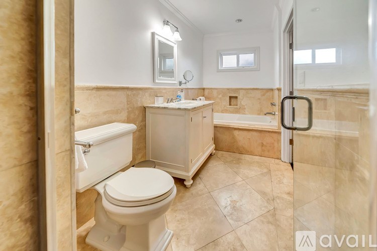A bathroom with a toilet, sink, and bathtub.