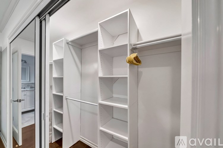 A white pantry with shelves and a yellow object on the shelf.