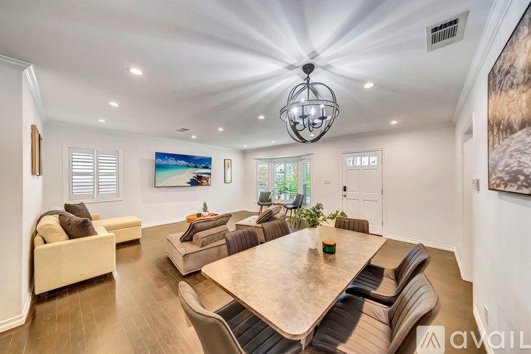 A modern living room with a large table and chairs.