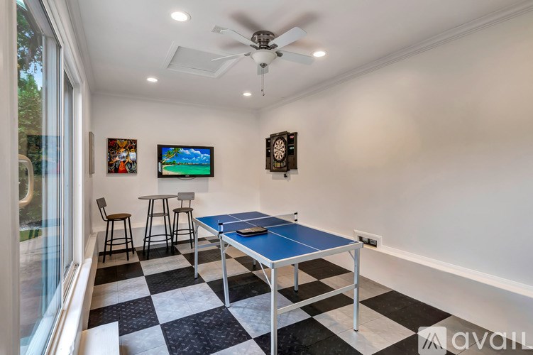 A room with a blue table and a ceiling fan.