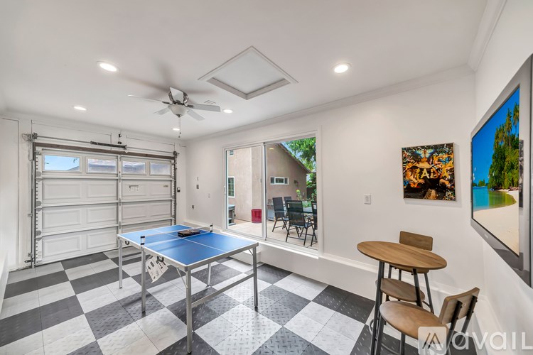 A room with a blue table and a ceiling fan.