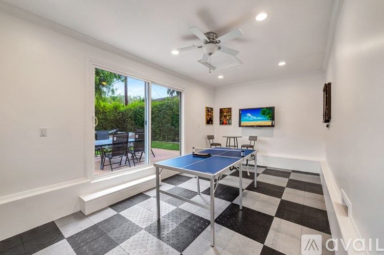 A room with a blue table and a ceiling fan.