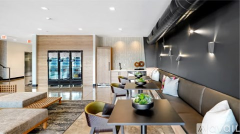 A modern living room with a long table and chairs.