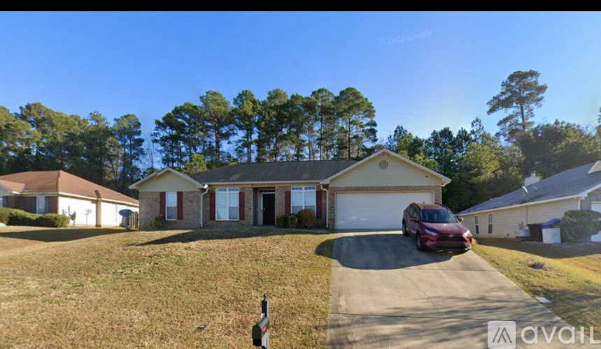 A house with a red car parked in front of it.