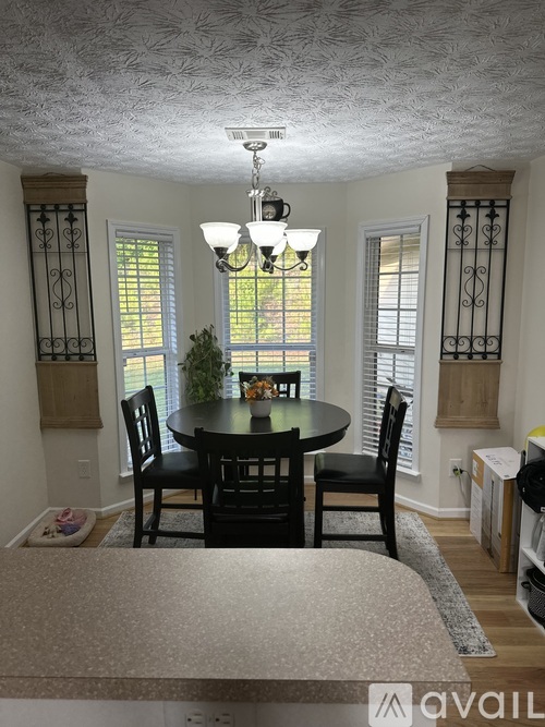 A dining room with a table and chairs.