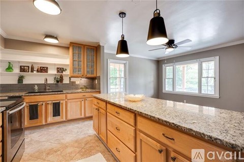 A kitchen with wooden cabinets and granite countertops.