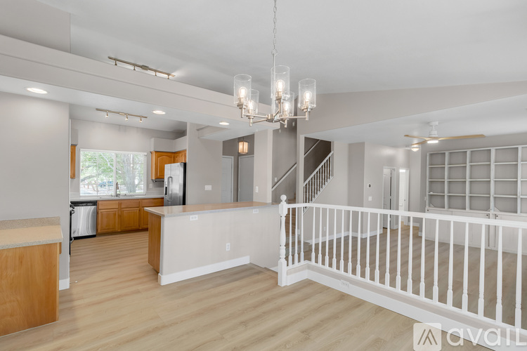 A spacious living room with a staircase leading to the upper floor.