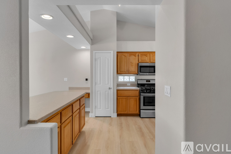 A kitchen with wooden cabinets and a white refrigerator.