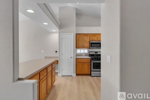 A kitchen with wooden cabinets and a white refrigerator.