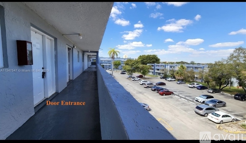 A view of a parking lot from a building entrance.