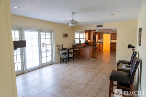 A living room with a dining table and chairs.