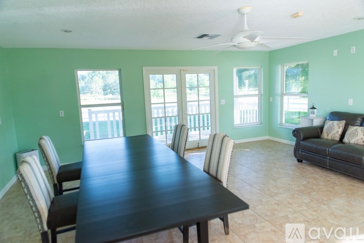 A dining room with a long table and chairs.