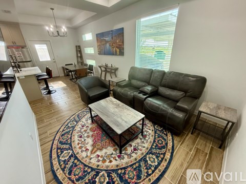A living room with a rug and a couch.